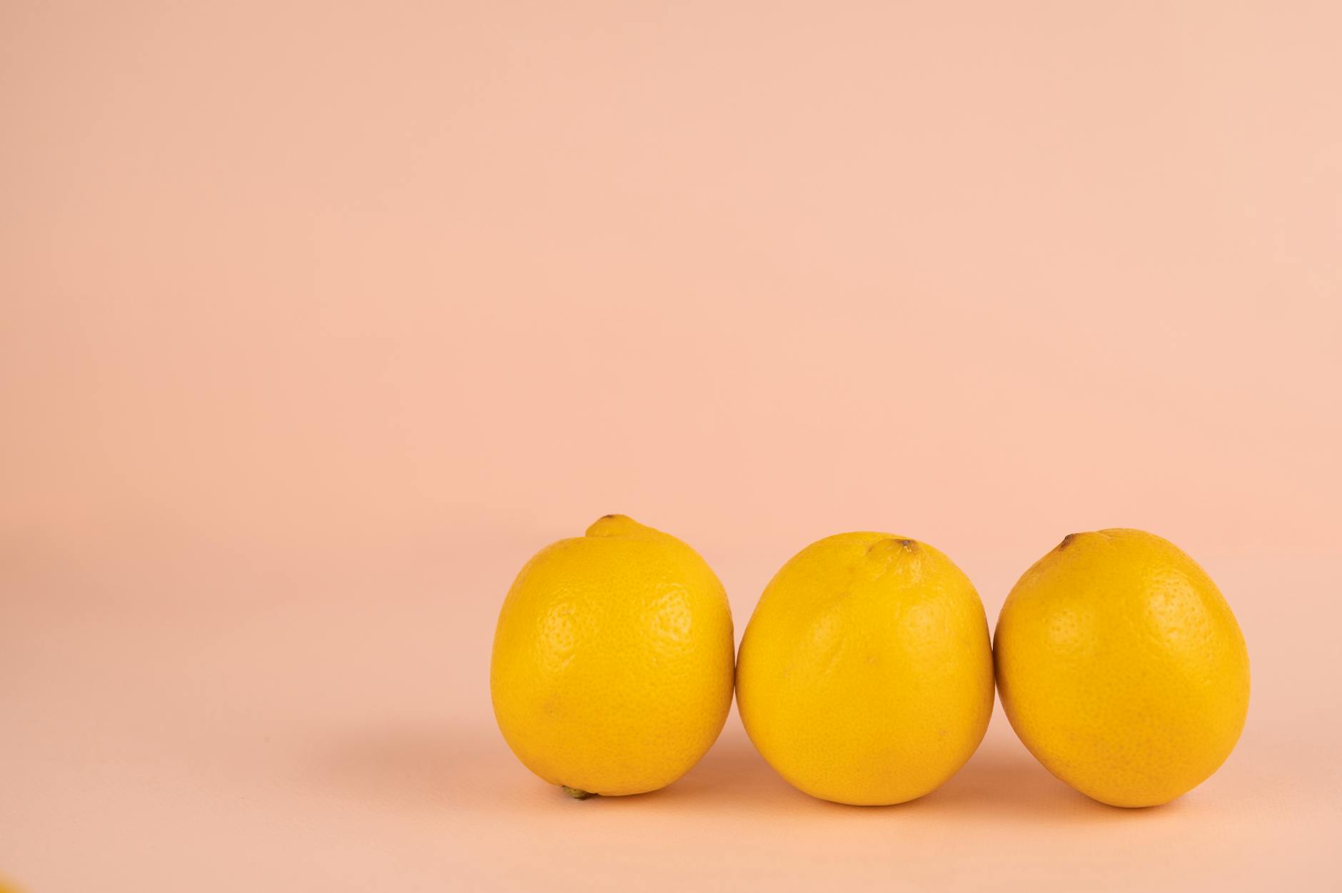 Bright ripe lemons arranged on a pastel background, symbolizing the Lemon vibrator