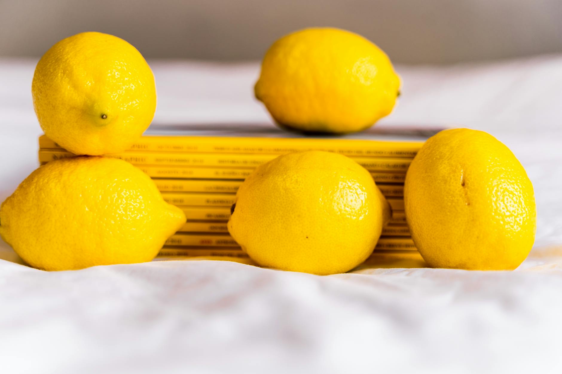 Bright yellow lemons on a yellow background representing the Lemon Nancy Shop brand and new relationship energy